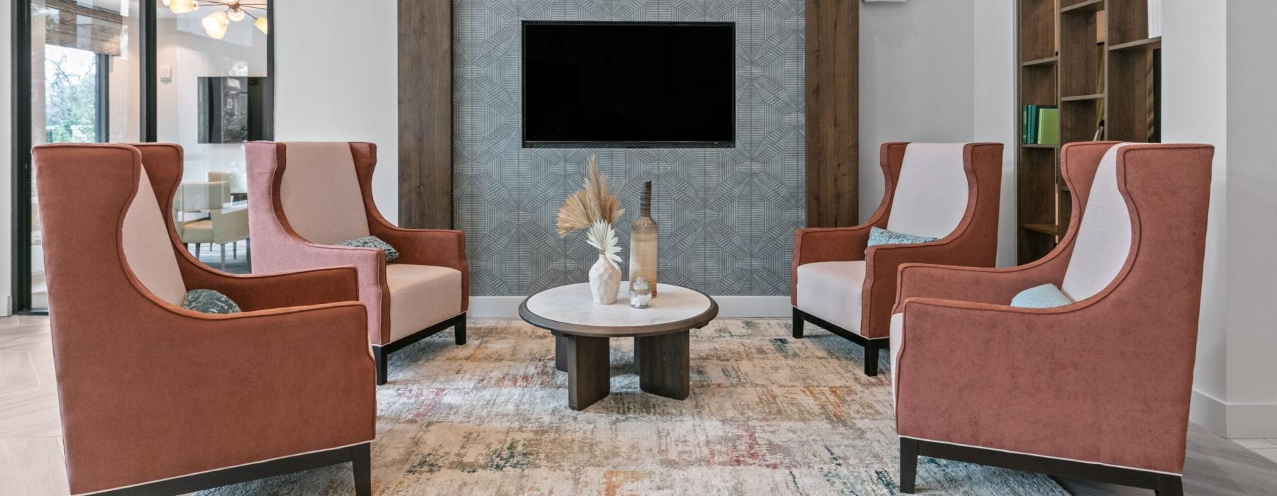 a lounge with chairs and a tv