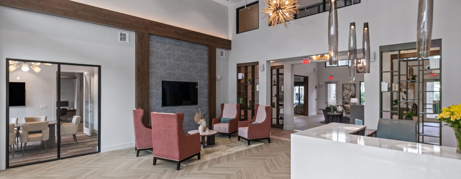 a large lounge with chairs and a tv